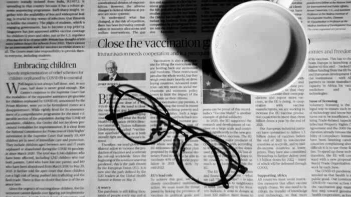 Photo of a newspaper with glasses and a mug