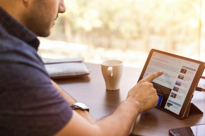Photo of a man scrolling LinkedIn