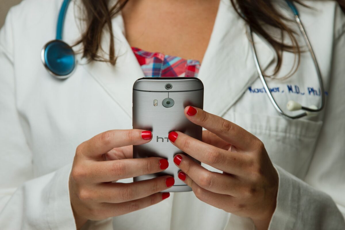 A photo of a doctor on a smartphone.