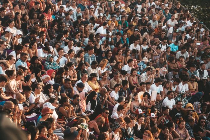 An image showing a huge crowd of people sitting