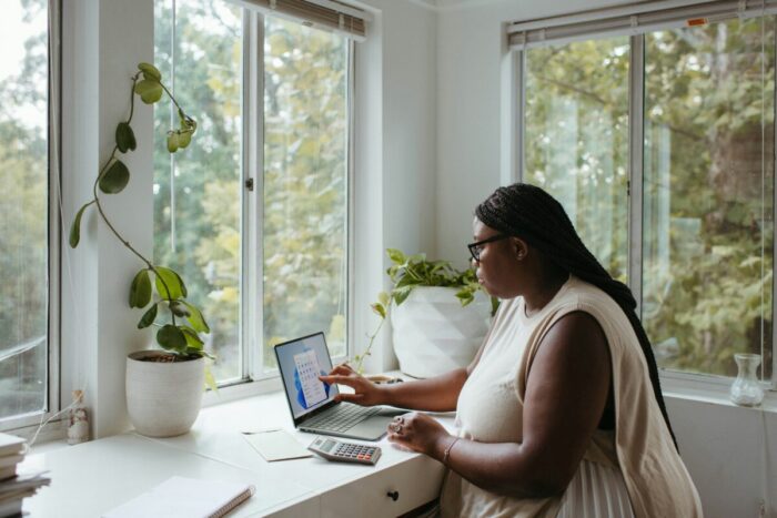 Photo showing a black female employee working from home.